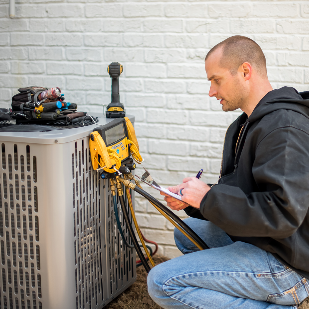 technician repairing an air conditioner installed outside a jupiter residence