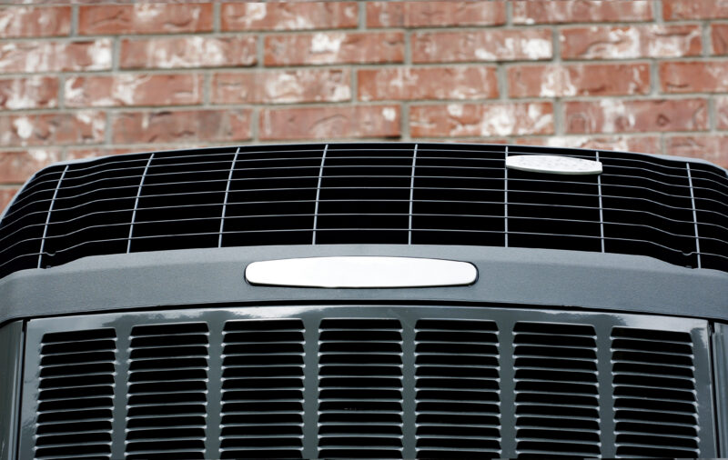 closeup of newly installed ac unit outside a home in jupiter with red brick