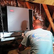 technician installing a dehumidifier inside a jupiter home