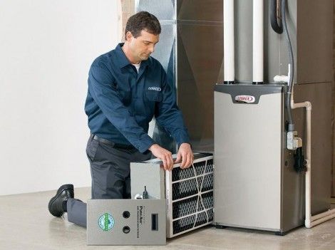 technician working on ac unit during maintenance visit in a jupiter home