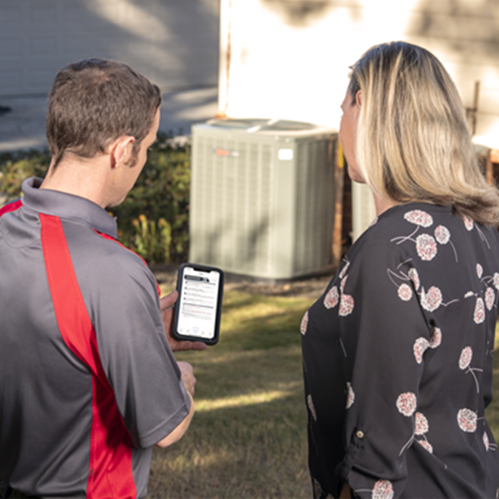 friendly technician talking to a homeowner after a maintenance visit