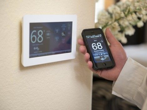 homeowner controlling their jupiter home's smart thermostat from their phone using wifi