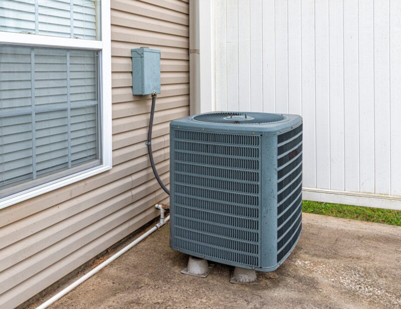 single outdoor hvac unit outside on the side of a residential home